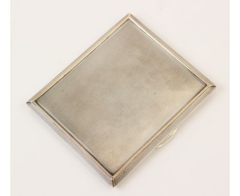 A silver cigarette case by A Wilcox, Birmingham 1940, of rectangular form with engine turned decoration and gilt borders to f