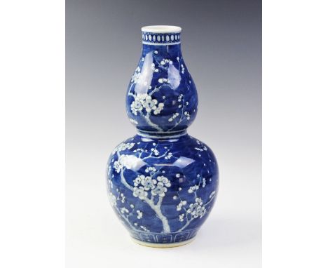 A Chinese porcelain blue and white prunus pattern gourd vase, Kangxi four character mark (late 19th century), 38cm high For c