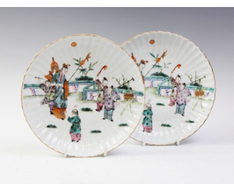 A pair of Chinese porcelain plates, Qianlong seal mark (20th century), each of circular scalloped form and centrally decorate