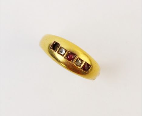 An 18ct gold diamond and ruby ring, comprising two small mixed cut rubies and two rose cut diamonds, each claw set in yellow 