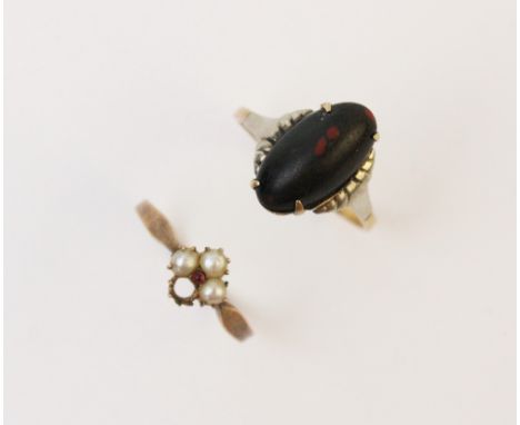 An Edwardian seed pearl and ruby set floral cluster ring, the shank stamped '9ct', ring size L 1/2, together with a bloodston