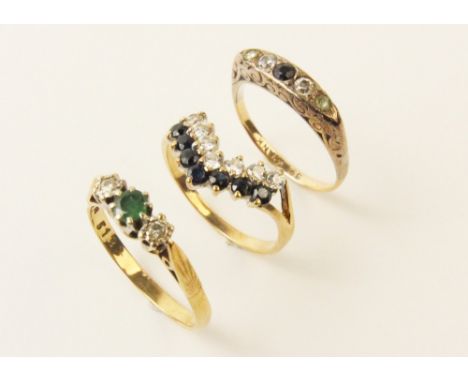 An emerald and diamond 9ct gold ring, comprising a small round mixed cut emerald with a small brilliant cut diamond set to ei