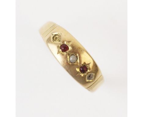 An early 20th century ruby and pearl set ring, comprising a small seed pearl with a small mixed cut ruby to each side, set in