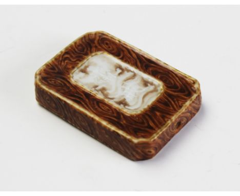 A Chinese porcelain scroll weight/pendant, 20th century, of rectangular form with canted corners, marbled decoration surround