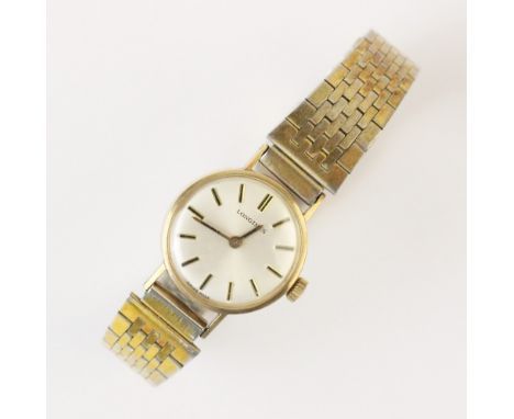 A lady's vintage Longines 9ct gold wristwatch, the circular white enamel dial with baton markers, set to a plain polished 9ct