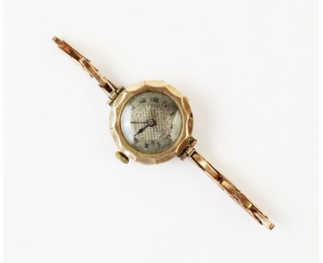 A lady?s 9ct gold vintage wristwatch, the silvered dial with engine turned decoration and roman numerals, set to a 9ct gold c