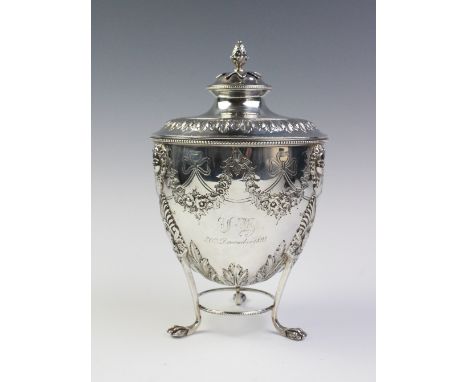 A late Victorian silver caddy by Martin, Hall &amp; Co, Sheffield 1893, the urn shaped body resting on three paw feet, detach