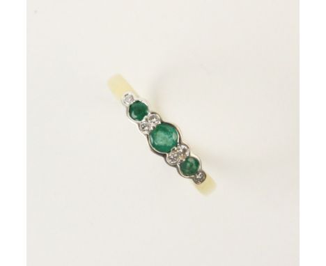 An emerald and diamond 18ct yellow gold ring, comprising three round mixed cut emeralds measuring between 2mm diameter and 3m