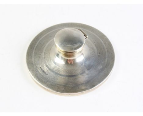 A silver capstan inkwell, Birmingham 1930, with engine turned decoration and mahogany base, 12.8cm wide 