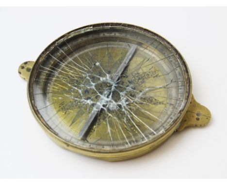 A George III  brass compass in the manner of George Adams, of circular form with extensive chased decorated to the central pl