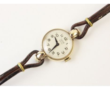 A lady's vintage Tudor 9ct gold wristwatch, the round white enamel dial with Arabic numerals, set to a plain polished 9ct gol