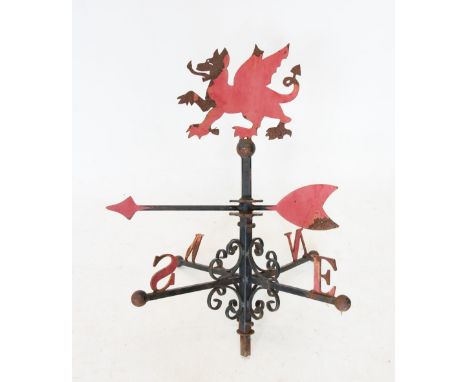 An early 20th century Welsh dragon wrought iron weather vane, the painted dragon above a revolving arrow pointer and the N E 