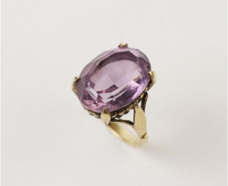 An amethyst set 9ct gold dress ring, comprising an oval mixed cut amethyst measuring 16mm x 12mm, claw set in yellow gold to 