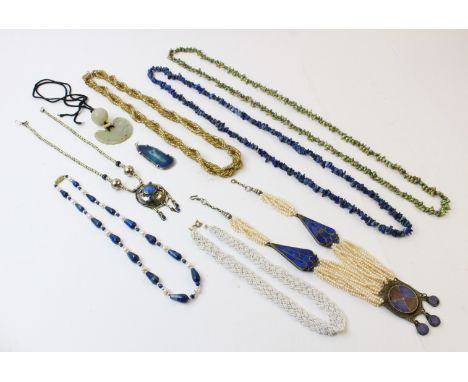 A selection of lady's costume jewellery, to include a carved jade pendant, an agate set pendant, an Eastern style white metal