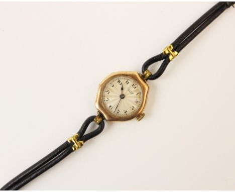 A lady's vintage 9ct gold Rolex wristwatch, the round cream dial with engine turned decoration and Arabic numerals, set to a 