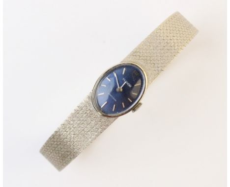 A lady's vintage 14ct white gold Tudor wristwatch, the blue oval shaped dial with baton markers, set to a plain polished whit