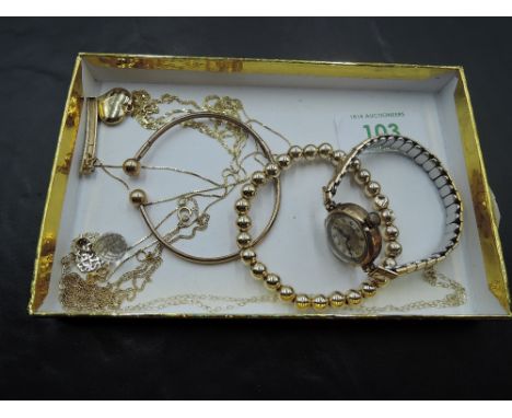 A selection of 9ct gold jewellery including torque bangle, heart pendant, chains and a lady's vintage 9ct gold wrist watch wi
