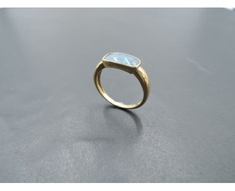 A 9ct gold ring having a faux black opal panel in collared mount, size L &amp; approx 2g