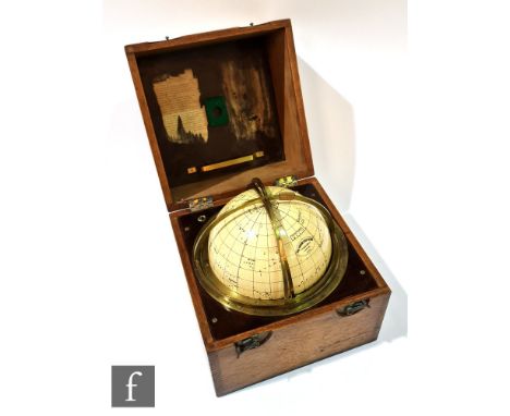 A Huston Star globe by H.Hughes &amp; Son London 1920, set into a brass scale frame and ebonite panel, mahogany case, width 2