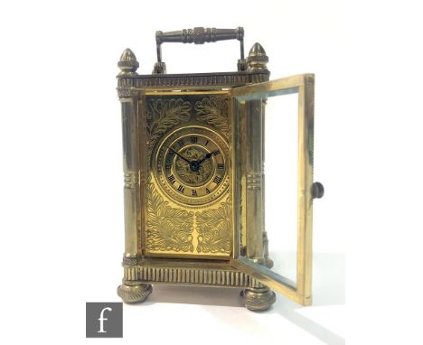 An early 20th Century miniature brass carriage clock, probably French, with bevelled glass panels and an engraved brass dial,