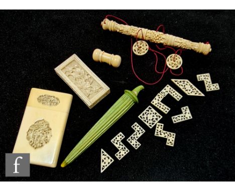 A late 19th Century ivory rectangular card case with detailed inset panel, a carved ivory bodkin case, a similar stained gree