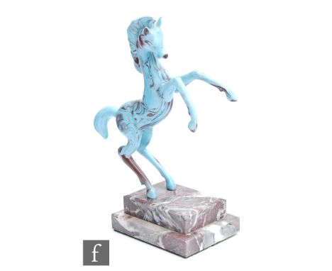 An Istvan Komaromy figural lamp work group of a prancing stallion in tonal blue opalescent glass, mounted to a stepped variga
