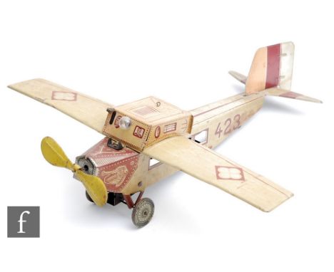 A 1930s Georg Fischer tinplate clockwork aircraft, with printed detail in cream and red, numbered 423, integral key to propel