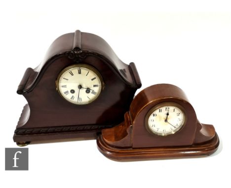 An Edwardian mahogany cased mantle clock, serpentine shaped case and a similar smaller mantle clock, width 31cm. 