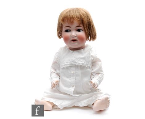 An early 20th Century Kley and Hahn bisque socket head character doll, with sleeping flirty brown eyes, open mouth with teeth