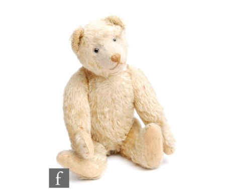 An early 20th Century German teddy bear, possibly Steiff, circa 1910, blonde clipped hair with shaved muzzle, disc jointed bo