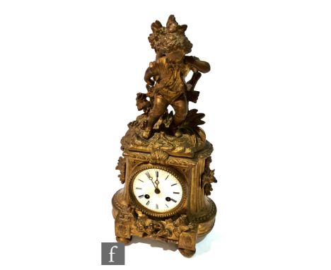 A late 19th Century French gilt mantel clock surmounted with a boy carrying a basket of corn, white enamelled dial, height 39