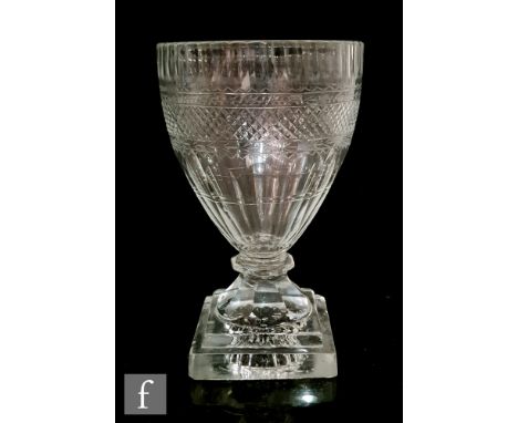 A large late Georgian rummer circa 1800, the ovoid bowl cut and engraved with panels of decoration above a slice cut base, ab