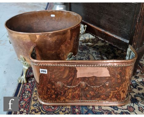 A small Edwardian copper fender, width 46cm, and a post 1950s Regency style oval copper log bin on brass paw feet, width 43cm