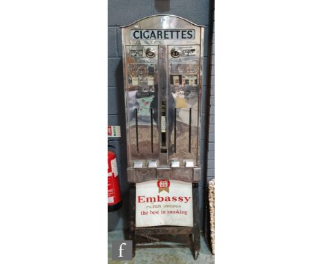 A post 1950s Embassy chrome plated floor standing cigarette dispenser, the arch top with illuminated ? Cigarettes? sign, two 