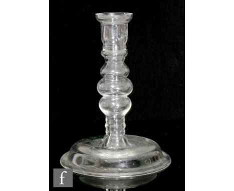 A 19th Century clear crystal glass candlestick or section of a lamp base, having a wide domed foot and a bobbin blown stem wi