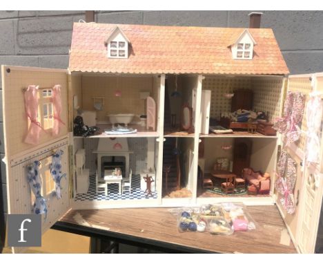A contemporary two storey dolls house with hinged roof attic, split front opening and interior walls with doors, painted in p
