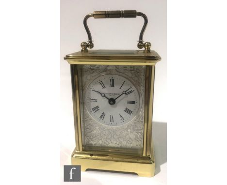 A Taylor and Bligh contemporary English carriage clock, the white enamelled dial and bevelled glass side panels with silvered