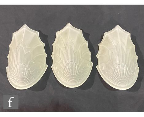 A set of three Art Deco fan shaped frosted glass wall light shades, each of stylised naturalistic form, relief moulded and fr