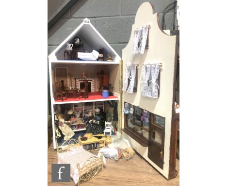 A two storey dolls house with attic room, single hinged front opening, wired lighting, the downstairs room modelled as a dres