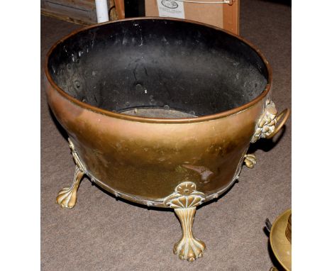 Brass two-handled oval planter applied with lion mask ring handles and raised on paw feet, 18cm long  