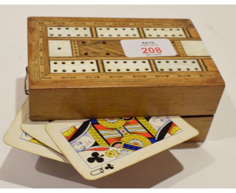 Vintage folding cribbage scoreboard containing various cards  