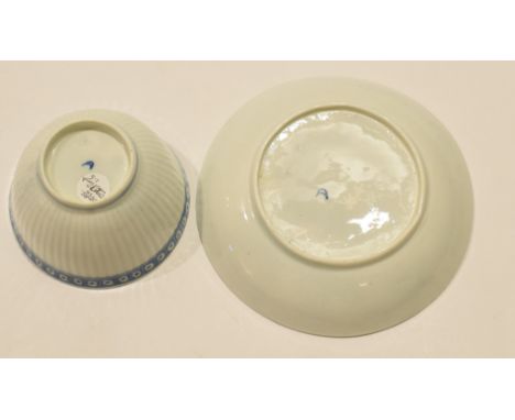 18th century Worcester porcelain tea bowl and saucer, the body with reeded moulding within a blue cell border  