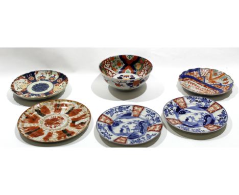 Group of Japanese porcelain wares including three Arita plates with blue and white designs and further plates and bowl with I