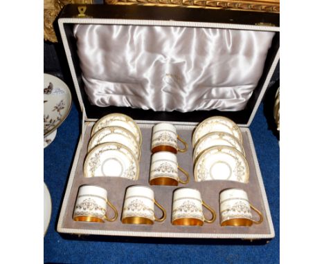 Minton Porcelain boxed coffee set with a gilt design, comprising six coffee cans and saucers, together with a further boxed s
