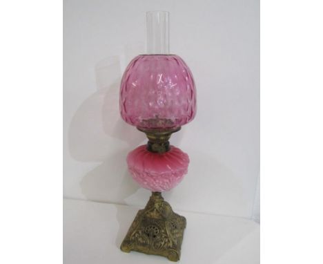 ANTIQUE OIL LAMP, ornate brass square base oil lamp with pink milk glass reservoir and cranberry shade 