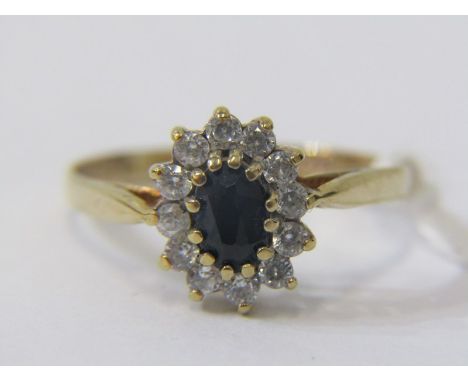 SAPPHIRE CLUSTER RING, 9ct yellow gold ring, set a central oval sapphire within a cluster, size N 
