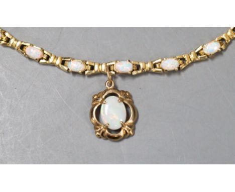 A modern 585 yellow metal and fourteen stone opal set drop bracelet, 19.3cm, gross weight 10.7 rams.**CONDITION REPORT**PLEAS