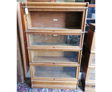 A Globe Wernicke oak 4 section bookcase, one door lacks glass, width 86cm, depth 27cm, height 148 cm.**CONDITION REPORT**PLEA