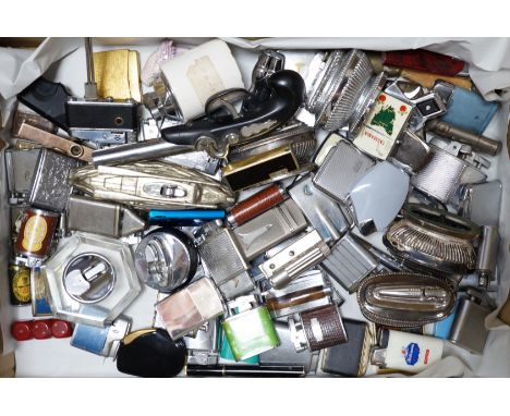A collection of lighters including some novelty examples such as a percussion cup pistol, a KKW lighter camera, and a spy cam