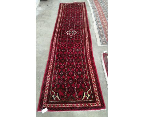 A North West Persian red ground runner**CONDITION REPORT**PLEASE NOTE:- Prospective buyers are strongly advised to examine pe